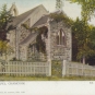 Colour postcard of stone church with ivy and white picket fence