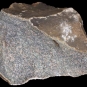 Colour image of gray rock with small black and white spots